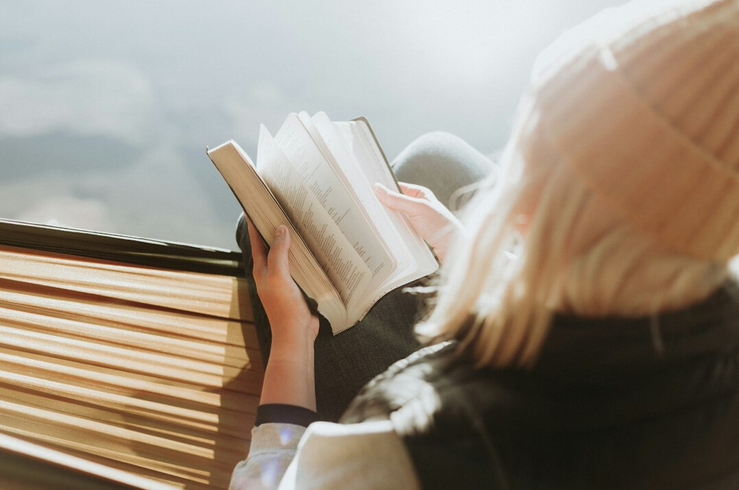 person reading book on leadership